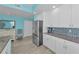 Bright kitchen with stainless steel refrigerator, granite countertops, and modern cabinetry at 19519 Gulf Blvd # 203, Indian Shores, FL 33785