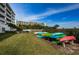 Manicured lawn area with kayaks and paddleboards neatly racked and ready for fun at 19519 Gulf Blvd # 203, Indian Shores, FL 33785