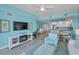 Bright living room with coastal decor, fireplace, and an open layout to the kitchen at 19519 Gulf Blvd # 203, Indian Shores, FL 33785