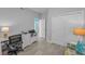 Bright office features modern desk setup, neutral color scheme, and comfortable sofa at 19519 Gulf Blvd # 203, Indian Shores, FL 33785