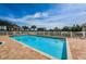 Sparkling community pool with brick paver decking, gazebo, and manicured landscaping at 19519 Gulf Blvd # 203, Indian Shores, FL 33785
