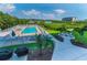 Exterior pool with lush landscaping, community grill, and a charming gazebo perfect for relaxation at 19519 Gulf Blvd # 203, Indian Shores, FL 33785
