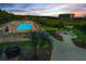 Exterior pool with lush landscaping, community grill, and a charming gazebo perfect for relaxation at 19519 Gulf Blvd # 203, Indian Shores, FL 33785
