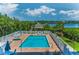 Community pool and a charming gazebo, all surrounded by lush landscaping with water views at 19519 Gulf Blvd # 203, Indian Shores, FL 33785