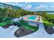 Inviting community pool with hot tub, lounge chairs, and gazebo surrounded by lush landscaping with water views at 19519 Gulf Blvd # 203, Indian Shores, FL 33785