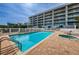 Community pool with jacuzzi and plenty of lounge seating for residents and guests at 19519 Gulf Blvd # 203, Indian Shores, FL 33785