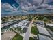 Stunning aerial view showcasing a coastal community with waterfront homes, canals, and clear skies at 2186 Edythe Dr # 11, Dunedin, FL 34698