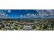 Wide angle aerial view of a waterfront community with winding canals and many beautiful clouds in the bright blue sky at 2186 Edythe Dr # 11, Dunedin, FL 34698