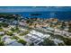 Waterfront homes offer canal access, lush greenery, and stunning open water views under a partly cloudy sky at 2186 Edythe Dr # 11, Dunedin, FL 34698