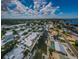 Waterfront neighborhood boasts canal access, community pools and lush greenery under a partly cloudy sky at 2186 Edythe Dr # 11, Dunedin, FL 34698