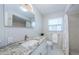 Bathroom features a granite countertop, tile shower, and ample lighting at 2186 Edythe Dr # 11, Dunedin, FL 34698