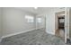 A cozy bedroom with laminate flooring, a ceiling fan, and a mirrored closet at 2186 Edythe Dr # 11, Dunedin, FL 34698