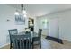 Cozy dining area featuring a round table, four chairs, and natural light from a window at 2186 Edythe Dr # 11, Dunedin, FL 34698