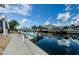 Scenic waterfront view featuring a private boat dock and canal access under a bright blue sky at 2186 Edythe Dr # 11, Dunedin, FL 34698