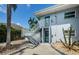 Multi-level exterior of building featuring stairs, landscaping, and well maintained grounds at 2186 Edythe Dr # 11, Dunedin, FL 34698