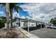 Exterior with covered parking and a two-story building with staircases and parking at 2186 Edythe Dr # 11, Dunedin, FL 34698