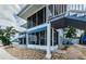 Exterior view of the building with a screened-in porch and tropical landscaping at 2186 Edythe Dr # 11, Dunedin, FL 34698