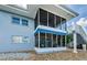 Exterior view of a screened lanai with a private staircase on a blue house at 2186 Edythe Dr # 11, Dunedin, FL 34698