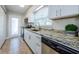 Well-equipped kitchen with stainless steel appliances, granite countertops, and bright lighting at 2186 Edythe Dr # 11, Dunedin, FL 34698