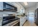 Modern kitchen showcasing stainless steel appliances, granite countertops, and a bright, airy feel at 2186 Edythe Dr # 11, Dunedin, FL 34698
