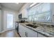 Updated kitchen with stainless steel appliances, granite countertops, and a door to the exterior at 2186 Edythe Dr # 11, Dunedin, FL 34698