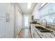 Bright kitchen featuring stainless steel appliances, granite countertops, and ample cabinet space at 2186 Edythe Dr # 11, Dunedin, FL 34698