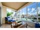 Screened lanai offering comfortable seating and a relaxing waterfront view at 2186 Edythe Dr # 11, Dunedin, FL 34698