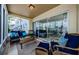 Inviting lanai featuring comfortable seating and sliding glass doors with canal views at 2186 Edythe Dr # 11, Dunedin, FL 34698