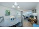 Bright and airy living room featuring an adjacent dining area and a screened lanai at 2186 Edythe Dr # 11, Dunedin, FL 34698