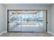 Open living room with sliding doors that open to the lanai with canal and boat access at 2186 Edythe Dr # 11, Dunedin, FL 34698