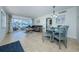 Open-concept living and dining area featuring stylish decor and an abundance of natural light at 2186 Edythe Dr # 11, Dunedin, FL 34698