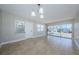 Bright living room with tiled floors, a ceiling fan, and sliders to outdoor water view at 2186 Edythe Dr # 11, Dunedin, FL 34698