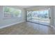 Bright living room features neutral paint, and access to the outdoor lanai with marina views at 2186 Edythe Dr # 11, Dunedin, FL 34698