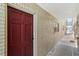 Exterior view of the unit entrance with a red door, number 7 and brick wall at 2207 S Carolina Ave # 7, Tampa, FL 33629