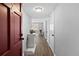 Inviting hallway with hardwood floors, a white console table, and a glimpse of the living area at 2207 S Carolina Ave # 7, Tampa, FL 33629