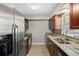 Galley kitchen featuring stainless steel appliances, granite countertops, and ample cabinet space at 2207 S Carolina Ave # 7, Tampa, FL 33629
