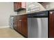 The kitchen features stainless steel appliances, granite countertops, and wood cabinets at 2207 S Carolina Ave # 7, Tampa, FL 33629