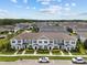 An aerial view of neighborhood with meticulously landscaped townhomes at 2432 Hearth Dr, Odessa, FL 33556
