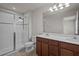 Bathroom with a glass shower, double sink vanity, and white countertop at 2432 Hearth Dr, Odessa, FL 33556