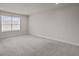 Bright, carpeted bedroom with ample natural light from the window at 2432 Hearth Dr, Odessa, FL 33556