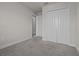 View of a bedroom featuring a closet with panel doors and gray carpeting at 2432 Hearth Dr, Odessa, FL 33556