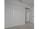 Carpeted bedroom with a closet featuring multiple doors and white trim at 2432 Hearth Dr, Odessa, FL 33556