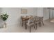 Bright dining room featuring a wooden table with seating for six, perfect for Gathering meals and entertaining guests at 2432 Hearth Dr, Odessa, FL 33556