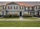 Charming townhome featuring a well-manicured lawn and inviting facade, perfect for modern living at 2432 Hearth Dr, Odessa, FL 33556
