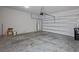 Spacious two-car garage featuring a concrete floor and white walls with garage door at 2432 Hearth Dr, Odessa, FL 33556