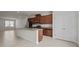 Open-concept kitchen with island, stainless steel appliances and tile floors at 2432 Hearth Dr, Odessa, FL 33556
