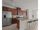 Modern kitchen featuring stainless steel appliances, a granite countertop island, and ample cabinet space at 2432 Hearth Dr, Odessa, FL 33556