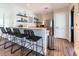 Modern kitchenette area featuring a breakfast bar with seating, stainless steel appliances, and wood grain flooring at 2432 Hearth Dr, Odessa, FL 33556