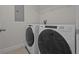 Laundry room area featuring a side by side white washer and dryer at 2432 Hearth Dr, Odessa, FL 33556