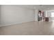 Spacious living room, showcasing tile floors adjacent to a modern kitchen at 2432 Hearth Dr, Odessa, FL 33556